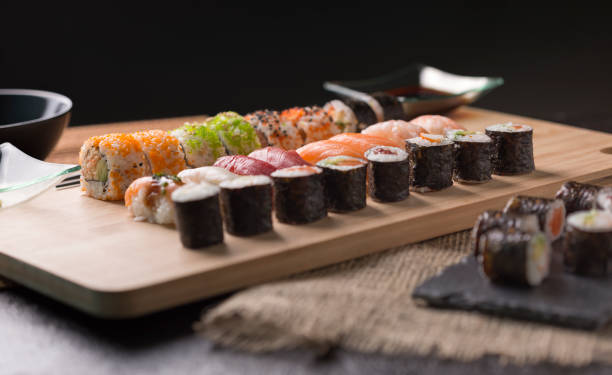 istock Sushi Set sashimi and sushi rolls served on stone slate 937956880