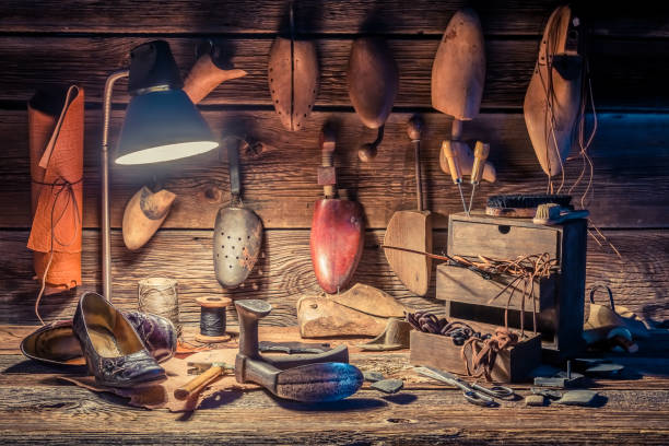 istock Vintage shoemaker workplace with brush, shoes and shoelaces 937959812