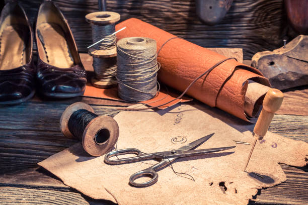 istock Closeup of tools, shoes and leather in cobbler workshop 937962220