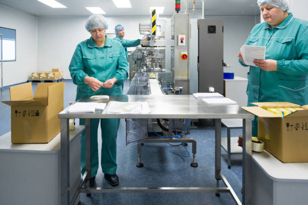 istock Pharmaceutical factory workers in sterile environment 937965884