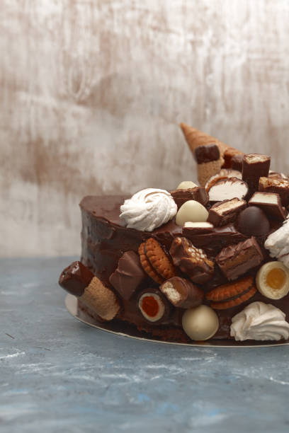 istock A festive chocolate cake decorated with a waffle horn, chocolate sweets, marshmallows, biscuits on a dark background 937966092