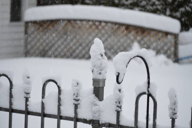 istock Snow accumulation on a fence during a snowstorm in winter time 937966106