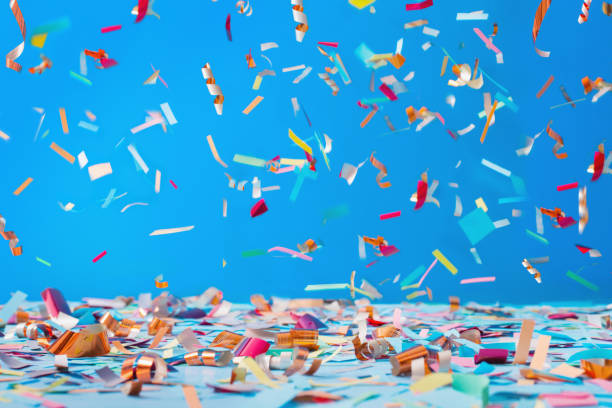 birthday confetti on blue background birthday confetti on blue background carnival celebration event photos stock pictures, royalty-free photos & images