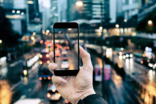 Holding smartphone in the city night