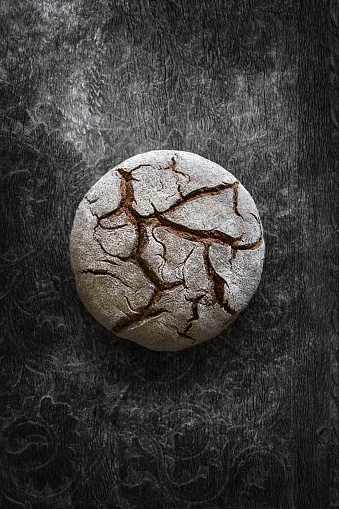 Fresh baked organic bread on dark background