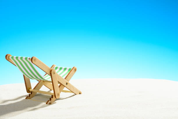 istock Sun lounger on the sandy beach 937975906