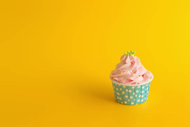 istock Tasty Birthday cupcake on yellow color background 937976060