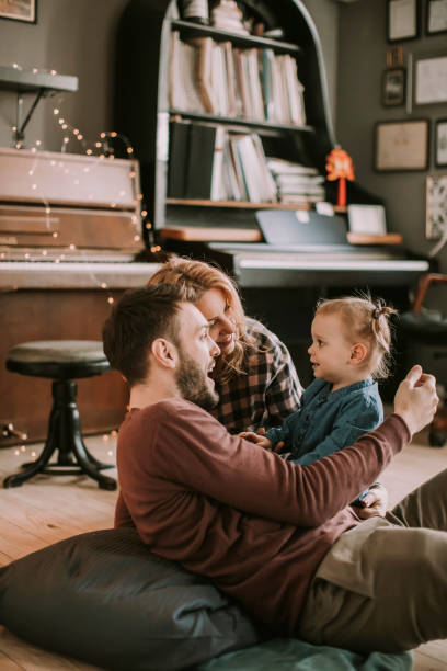 istock Happy young family playing on the floor 937976140