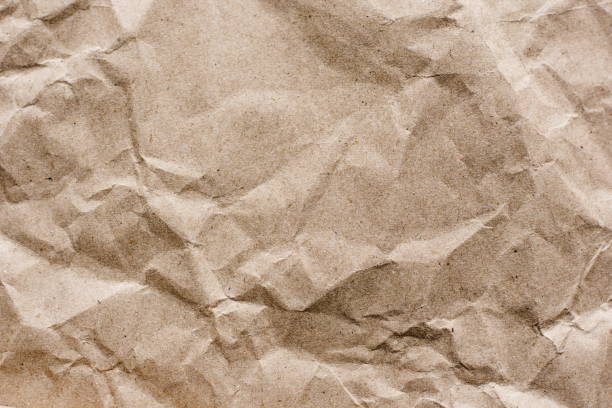 istock Textured brown craft paper close-up background copy space 937976208