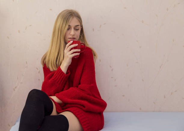 istock Young blonde girl having a coffee on the bed 937976774