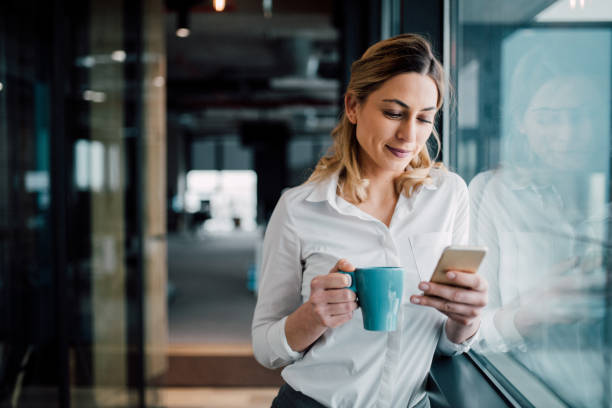 Professional Businesswoman texting Beautiful business woman Texting in the coffee break single cup stock pictures, royalty-free photos & images