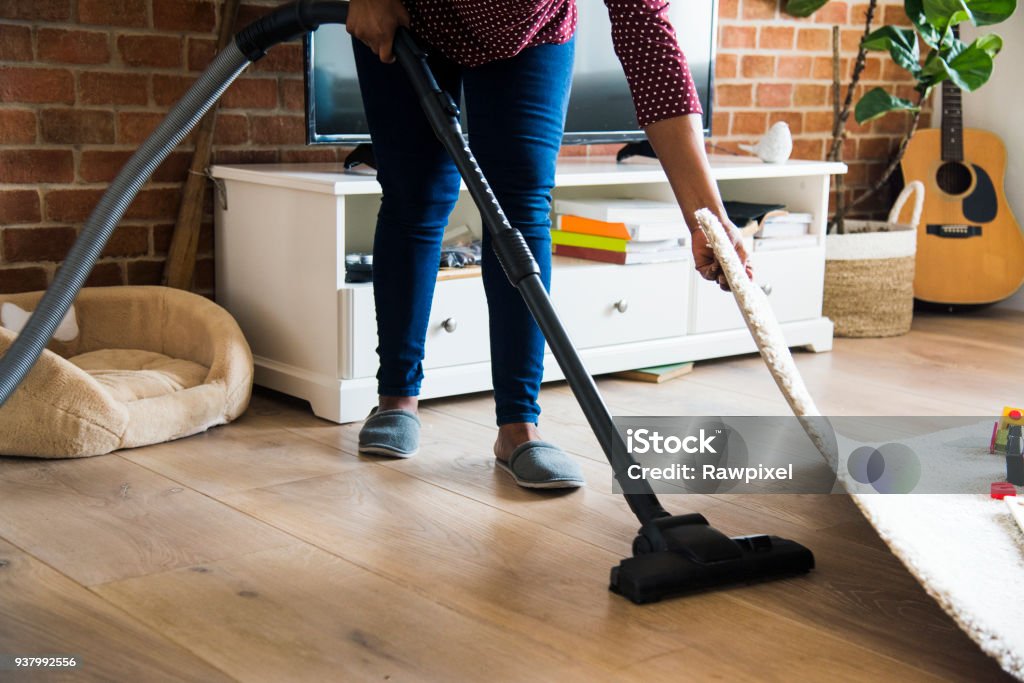 Black woman is cleaning room Cleaning Stock Photo