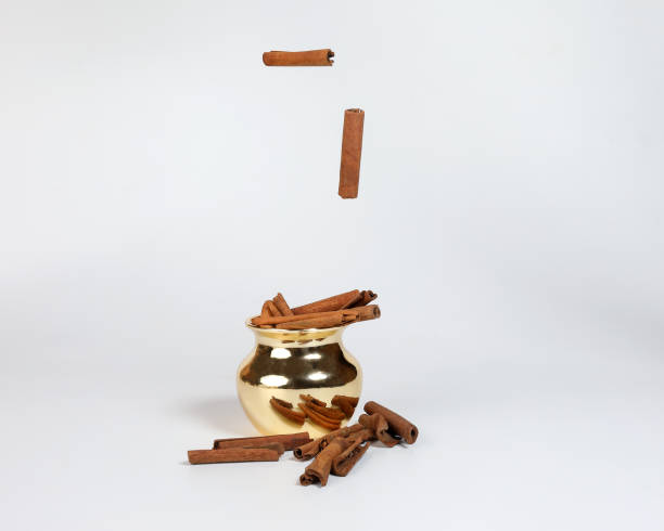 istock Cinnamon spice golden brass copper metal shiny pot container on white background 938007982