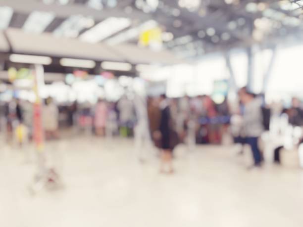 istock Abstract blurred image background of group people or arriving passengers with their suitcases and luggage walking in international  airport terminal, travelling or business concept. vintage tone. 938016416