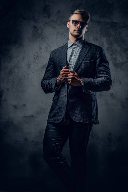 istock A man in a suit and sunglasses on grey background. 938017452
