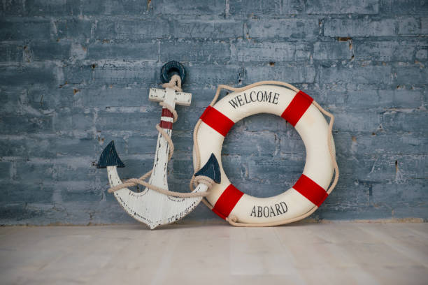 istock A composition on a sea theme with an anchor and life ring on a gray brick wall 938020886