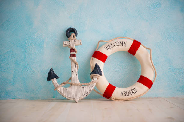 istock A composition on a sea theme with an anchor and lifebuoy on a blue wall 938023046
