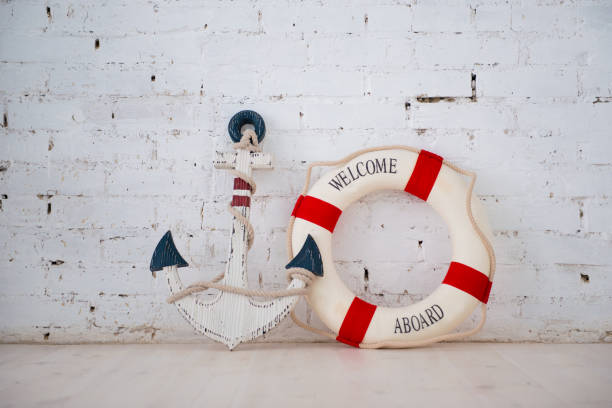 istock A composition on a sea theme with an anchor and life ring on a white brick wall 938023430