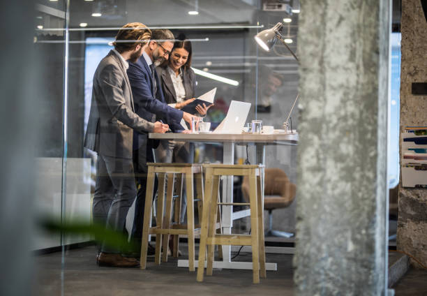 istock Team of entrepreneurs cooperating while working in the office. 938026626