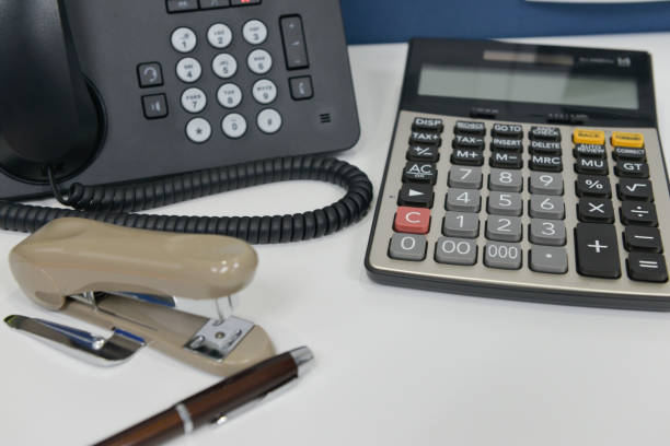 istock Office equipment with IP Phone, pen, stapler and calculator 938027702