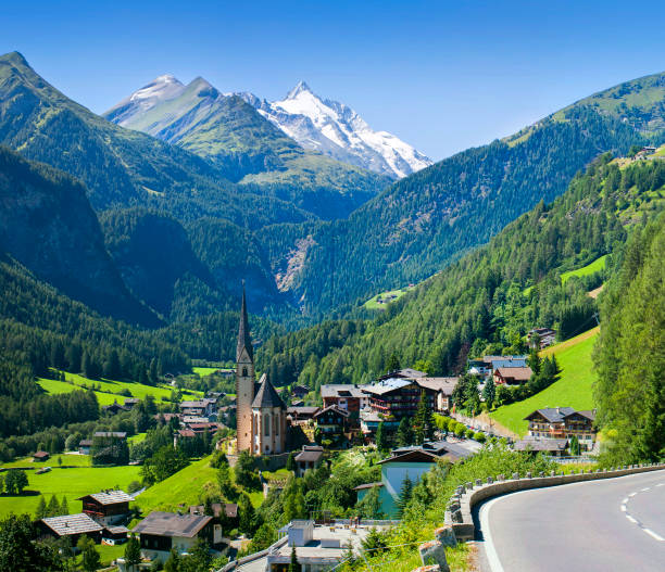 Heiligenblut church in Austria with Grossglockner peak Heiligenblut church in Austria with Grossglockner peak in background grossglockner stock pictures, royalty-free photos & images
