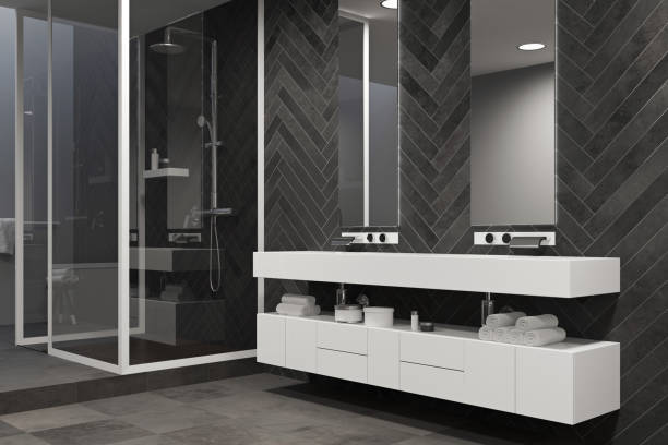 istock White sink vanity unit in a black bathroom, shower 938031802