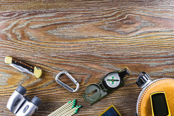 istock Hiking or travel equipment with compass, binoculars, matches on wooden background. Active lifestyle concept. 938034902