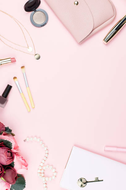 istock Flat lay home office desk. Female workspace with note pad, fashion accessories and make up products on pink background. Fashion or beauty blogger concept. 938034918