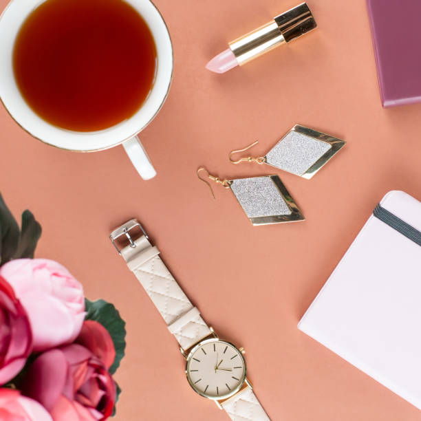 istock Flat lay home office desk. Female workspace with note pad, flowers, tea, chocolate cookies and fashion accessories. Fashion or beauty blogger concept. 938034942