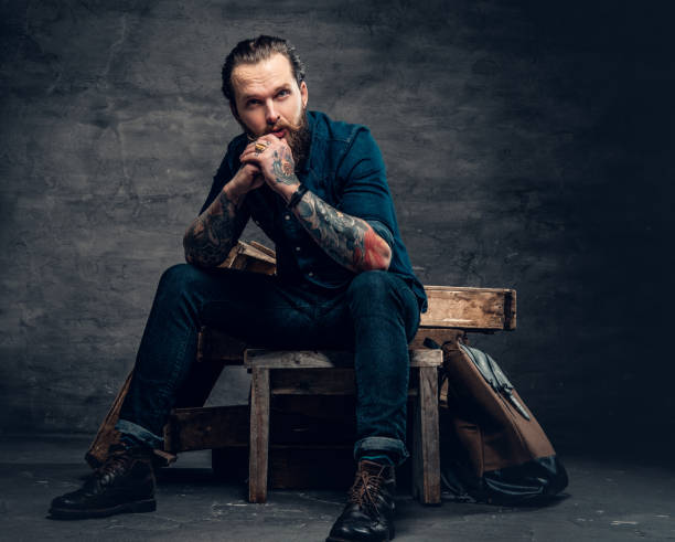 istock Bearded male with tattoos on arms. 938038426