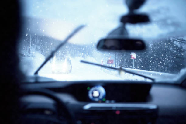 istock Snowy dangerous car overtaking on highway with Whiteout Conditions 938038442