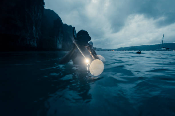Young woman night snorkeling at Phi Phi Island Phuket, Thailand