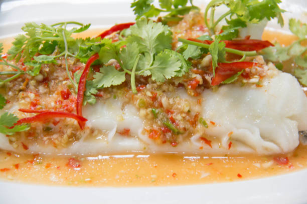 istock Steamed snow fish with spicy sauce 938041924