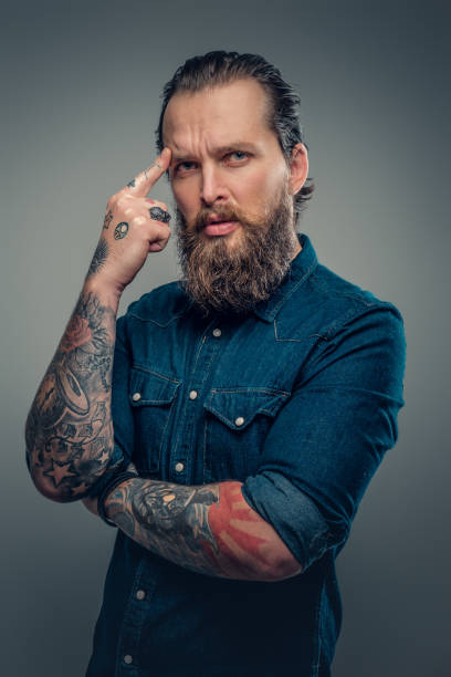 istock Bearded man with tattoos on arms. 938047800