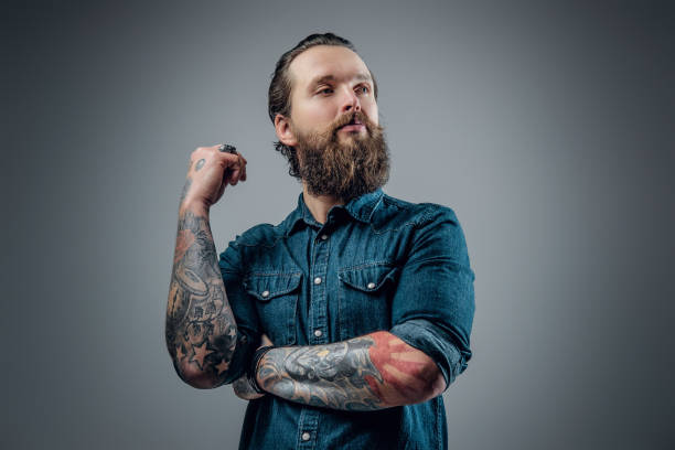 istock Bearded man with tattoos on arms. 938049308