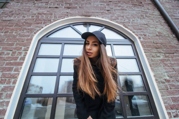 istock bottom view stylish beutiful girl in a black coat and black cap 938049704