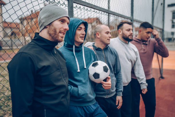 istock Best friends playing socceer on streets 938050262