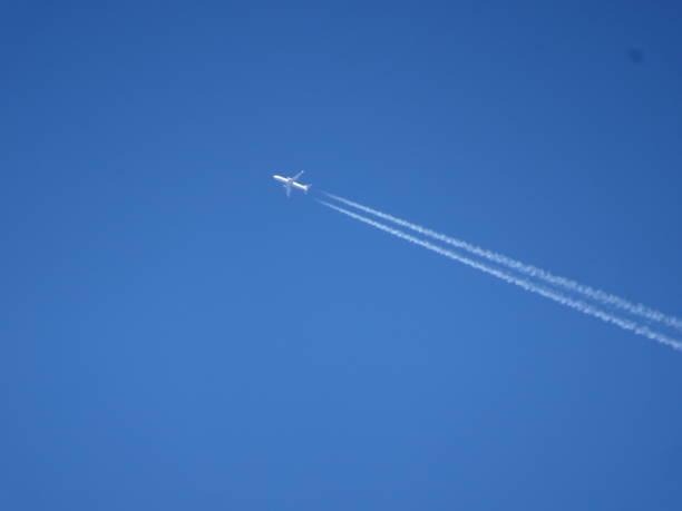 istock airplane and vapor trail 938050744