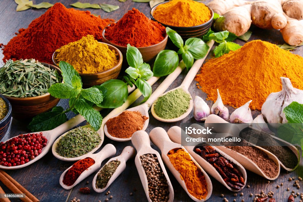 Variety of spices and herbs on kitchen table Variety of spices and herbs on kitchen table. Spice Stock Photo