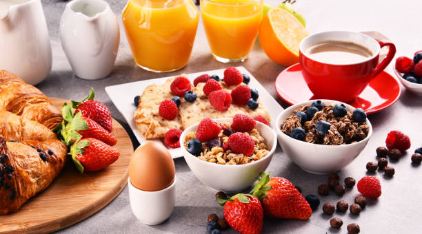 istock Breakfast served with coffee, juice, croissants and fruits 938050908