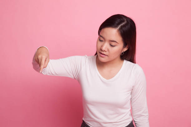 istock Beautiful young Asian woman point down to blank space. 938050910