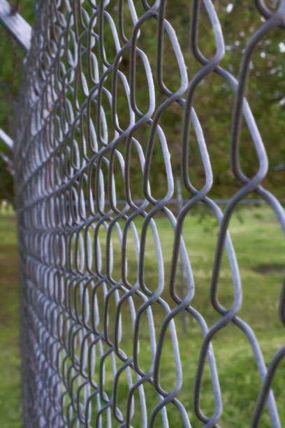 istock Closeup of chain link fence at dusk 938051116