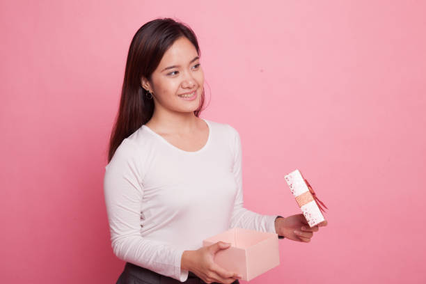 istock Young Asian woman open a gift box. 938053446