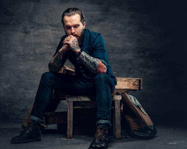istock Bearded male with tattoos on arms. 938053862
