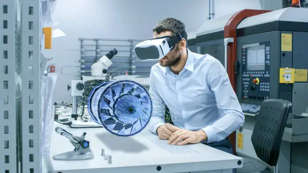 Factory Chief Engineer Wearing VR Headset Designs Engine Turbine on the Holographic Projection Table.  Futuristic Design of Virtual Mixed Reality Application.