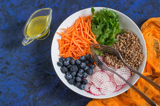 istock Vitamin vegetarian salad with buckwheat, vegetables and blueberries 938060448