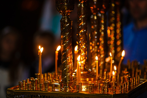 ambiance of church, candles and bokeh yellow lights