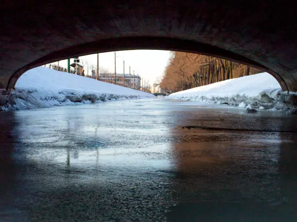 view from under the bridge on the river in winter