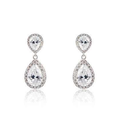 Pair of silver diamond earrings isolated on white background