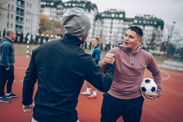 istock Best friends playing socceer on streets 938067778